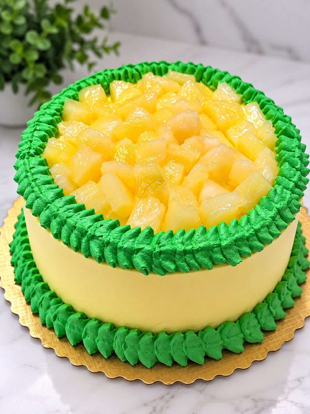 Pineapple cake with green piped border